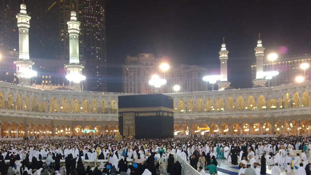 The Kaaba at night during Ramadan, with worshippers filling the Grand Mosque courtyard in Makkah