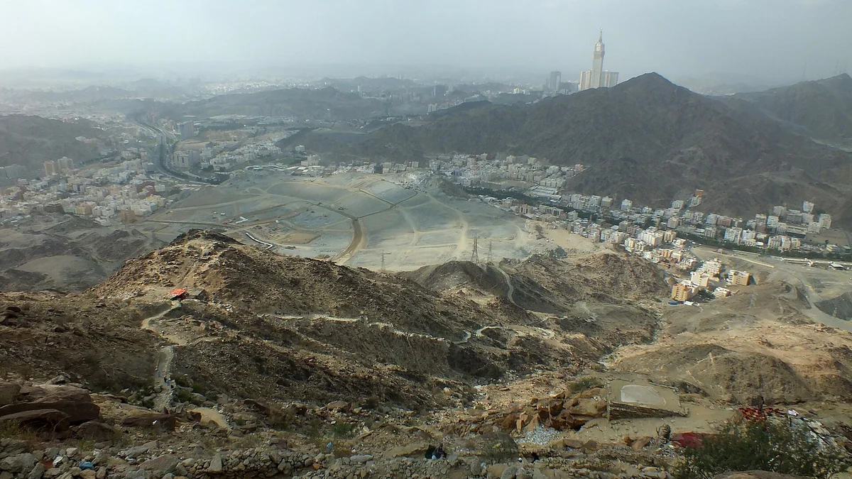 Rocky slopes in the Thawr area with Makkah and the Clock Tower in the distance